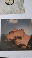 Front cover of the vinyl album showing John Lennon's head in profile against a cloudy sky.
