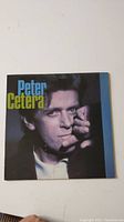 Front cover of Peter Cetera Solitudes/Solitaire vinyl record album showing a close-up portrait of Peter Cetera with the title text.