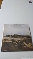 Front cover of The Moody Blues' Seventh Sojourn album showing a rocky landscape photograph in soft sepia tones.