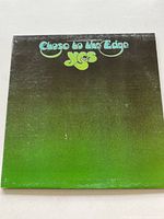 Front cover of Yes 'Close To The Edge' vinyl record album showing green gradient design with band name and album title.