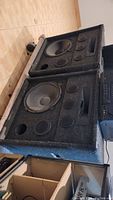 Two large speaker boxes stacked, showing front with drivers visible.