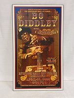 Full view of Bo Diddley poster with wooden guitar and vintage style text.