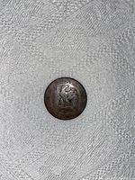 Reverse side of France 1861 2 Centimes coin showing imperial eagle design and wreath.