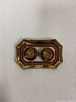 Top view of two miniature Limoges tea cups on their saucers, set on the rectangular tray with burgundy and gold decorations.