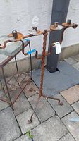 Full view of the wrought iron candle holder showing four candle holders and twisted central stem.