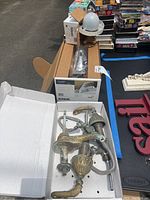 Photo showing two vintage Kohler Coralais faucet parts with ornate brass finish in a white box.