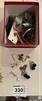 Box of mixed jewelry including pins, bracelets, necklaces, and loose parts