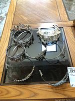 Top view of all six tiaras and crowns arranged on a table showing their relative sizes and styles.