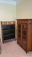 Photo showing both bamboo bookshelves together in a corner, the open bookshelf with black painted shelves and the bookcase with glass doors and drawers.