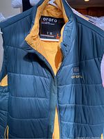 Dark green and yellow quilted Ororo jacket size XL, front view showing the logo and zipper.