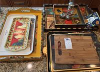 Overview of multiple serving trays in assorted prints and a bamboo cutting board