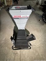 Front view of Craftsman electric chipper shredder showing hopper, body, and wheels