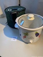 Photo of Rival Crock-Pot slow cooker with glass lid and insulated carrying case beside it