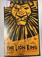 Front of The Lion King Broadway poster with cast signatures.