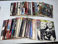 Full collection of 39 After Dark magazines laid out partially overlapping, showing diverse covers from the 1970s.