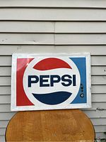 Front view of a rectangular metal Pepsi sign featuring the classic Pepsi logo in red, white, and blue.
