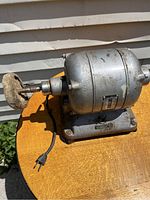 Right side angle showing the buffing wheel on the chrome mandrel and electric motor housing