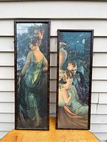 Full view of both narrow, tall framed prints showing two romantic couples in 1920s attire, outdoor setting.
