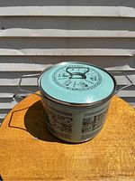 Front view of the Siltal enamelware pot showing integral handles and Egyptian hieroglyph decoration.