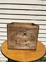 Front side of vintage pine butter box showing printed branding, weight, and label spaces