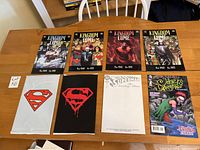Front covers of 4 Kingdom Come hardcover graphic novels and 4 softcover graphic novels/comics including Superman and Joker's Daughter