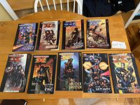 Front covers of Ultimate X-Men Volumes 1-9 displayed on table showing cover art and titles.