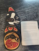Top view of killer whale carving showing full length and accompanying letter describing artist and provenance.