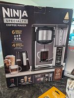 Photo of boxed Ninja Specialty Coffee Maker showing features and brand.