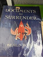 Cover of book 'Documents of Surrender World War II' shows title with flags of America, UK, and Soviet Union on dark blue cover.