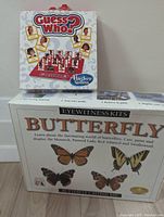 Photo showing Hasbro Guess Who game box and new butterfly puzzle casting kit box featuring images of butterflies