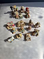 Image showing all 10 Bainbridge bear statues arranged on a flat surface in natural light, showing detailed designs and various poses.