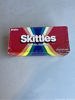 Original box for the collectible Skittles stock car model, with visible wear and tear.