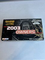 Black box with '2003 Owners' text and Hendrick Motorsports logo indicating limited edition status for a NASCAR die cast model.