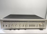 Front view of vintage Harman Kardon HK 330i stereo receiver with faceplate and controls visible.