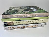 Stack view showing titles and spines of four books on country interior living and vintage homes