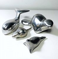 Four small polished pewter animal figurines by Hoselton Canada displayed together on white surface.