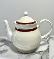 Full side view of the vintage white bone china Royal Grafton teapot from the Summer Wine series, showing the curved handle, spout, and the rounded body with red and gold banding.