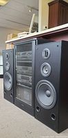 Front view of system with stacked components and tower speakers