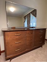 Dresser with large rectangular mirror mounted on top, showing full front view.