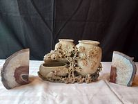 Front view of soap stone sculpture flanked by the pair of agate bookends on either side.