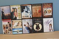 Full view of 10 DVD cases arranged in two rows of five, showing the movie titles and cover images for identification and condition assessment.
