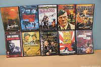 10 war movie DVDs including titles Apocalypse Now, The Longest Day, The Blue Max, The Dirty Dozen, The Bridge on the River Kwai, Clint Eastwood's The Gauntlet, Battle of the Bulge, Von Ryan's Express, Tora! Tora! Tora!, A Bridge Too Far
