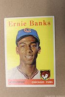 Front view of the 1958 Topps Ernie Banks baseball card #310 showing player image and team logo.