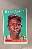 Full front view of 1958 Topps Hank Aaron #30 card showing green background, portrait and team text.