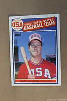 Front photo of Mark McGwire 1985 Topps 1984 USA Olympic Baseball Team baseball card showing player portrait with USA uniform and bat.