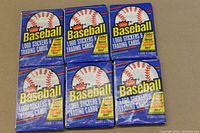 Front view of six 1988 Fleer Baseball Wax Packs with unopened blue packaging and baseball logo.