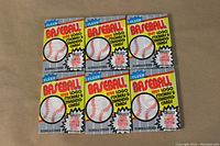 Six sealed 1989 Fleer Baseball wax packs shown front view with baseball design and logos.