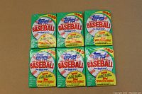 Front side of 6 unopened 1990 Topps Baseball wax packs showing the logo, promotional text, and packaging details.