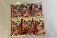 Front view of six 1994 Donruss Series 2 baseball foil packs showing the red and gold foil packaging and baseball player imagery, all unopened.