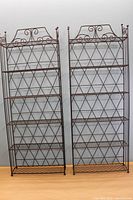 Front view of two metal shelving units side by side showing height and structure